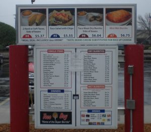 Taco Boy Drive-Thru Menu Board A drive-thru menu board for Taco Boy restaurant, displaying meal deals, single items, dry and wet burritos, dinners, and drinks with prices.