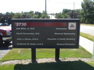2730 Business Directory Sign A business directory sign at 2730 featuring listings for insurance, optometry, and dentistry services, including a State Farm Insurance logo.